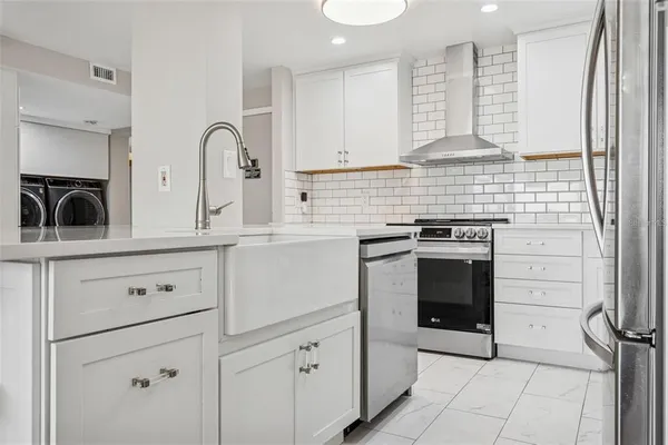a kitchen with a stove cabinets and a sink