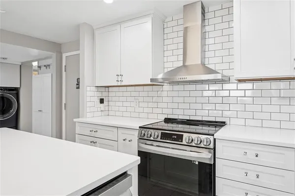 a kitchen with cabinets and appliances