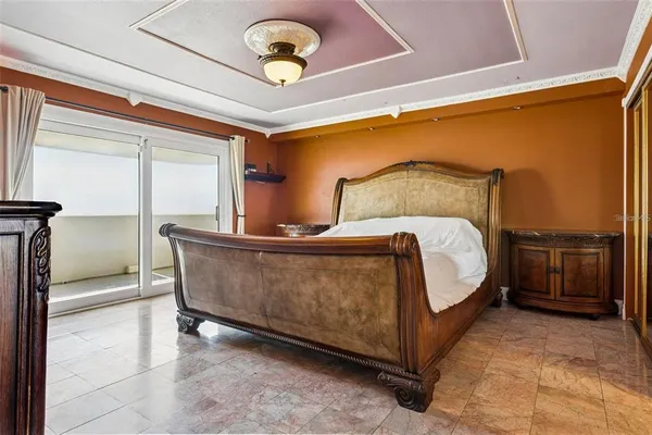 a bed room with a bed and a chandelier