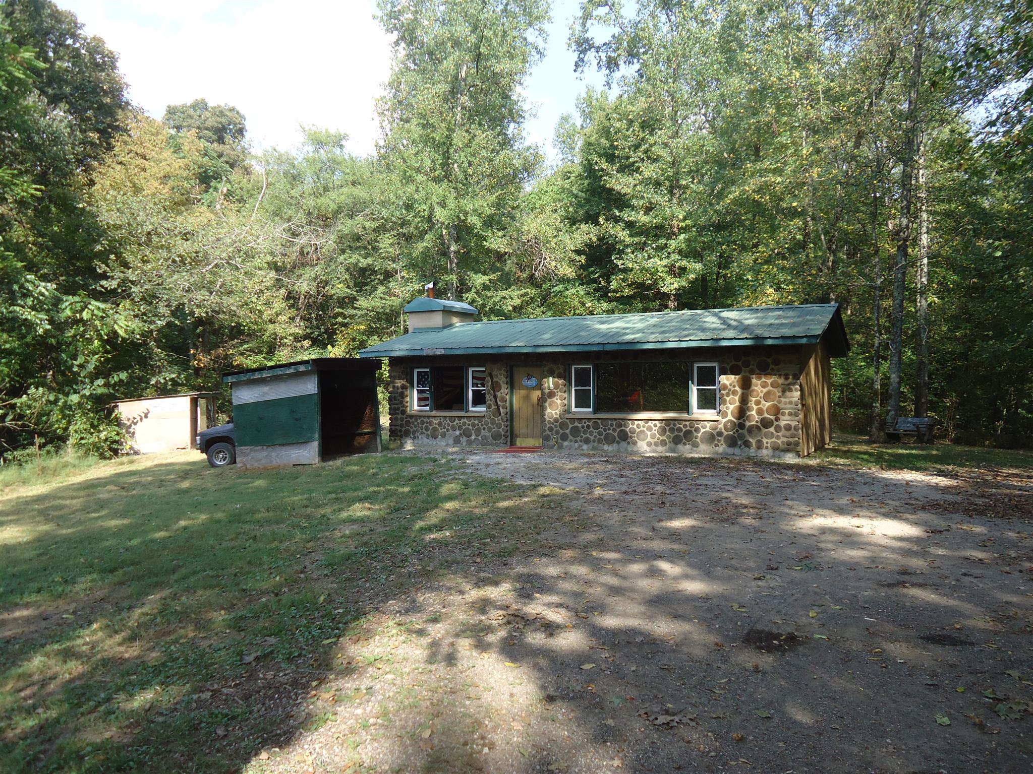 239 Loyd Road Pulaski, TN 38478 - Photo 6 of 19 a front view of a house with a garden