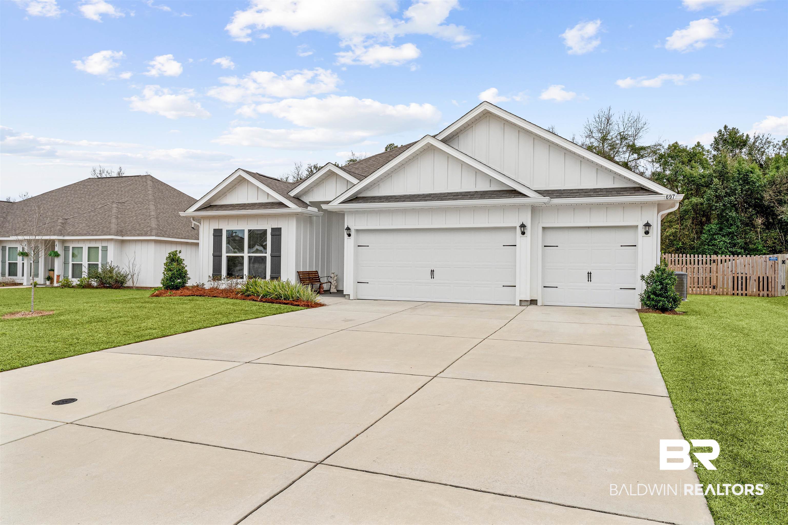 697 Calibre Street Fairhope, AL 36532 - Photo 1 of 18 Modern farmhouse style home with board and batten siding, driveway, an attached garage, and a shingled roof
