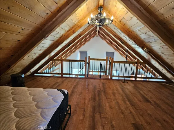 a living room with wooden floors and a black umbrella