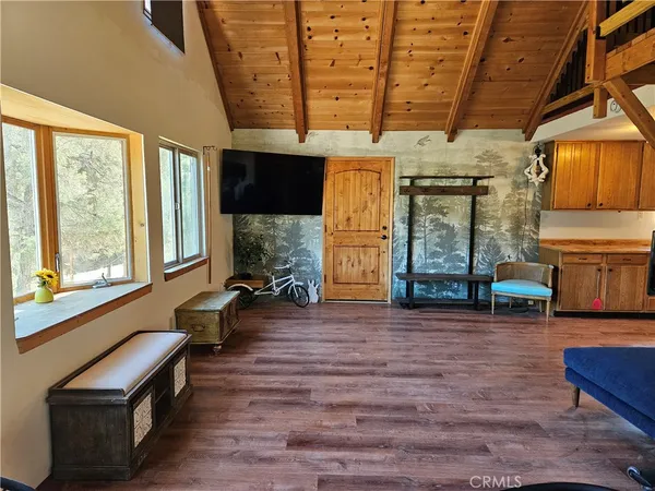 a view of hallway with furniture and wooden floor