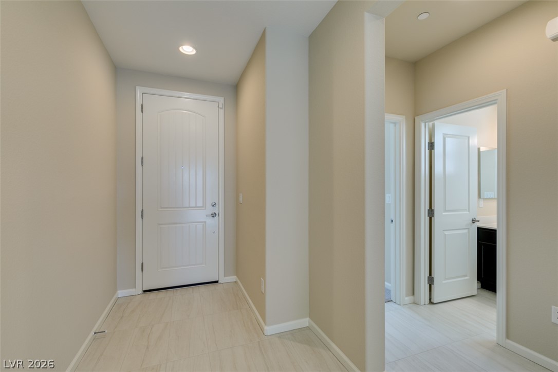 2549 Sable Ridge Street Henderson, NV 89044 - Photo 10 of 48 Recessed lighting illuminates the tiled entrance foyer, providing a welcoming glow.