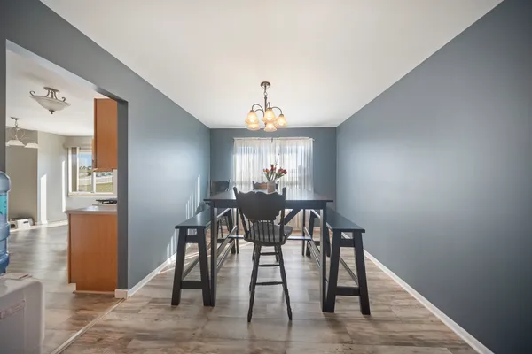 a view of a dining room with furniture and window