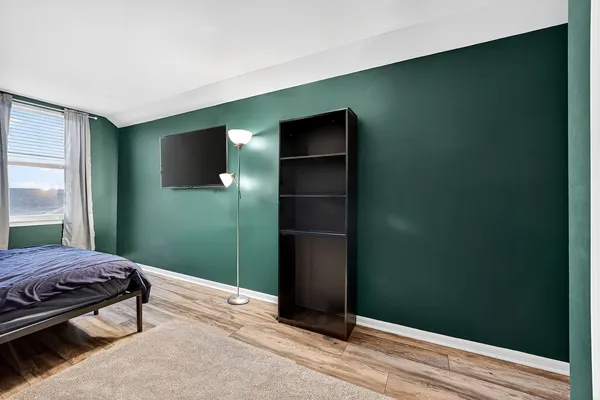 a bedroom with a bed and a window