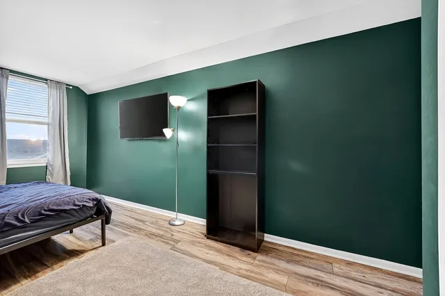 a bedroom with a bed and a dresser