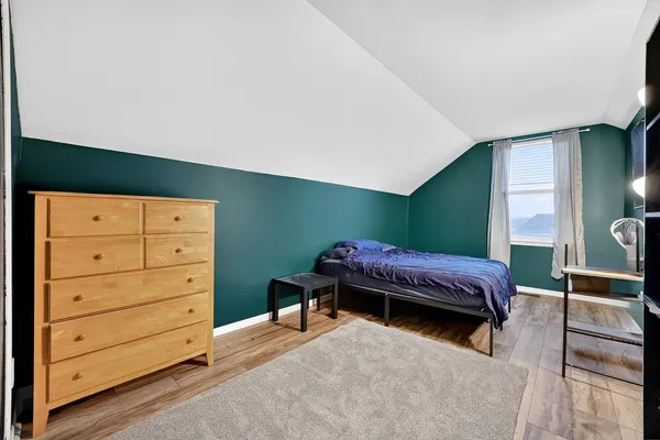 a bedroom with a bed and a dresser