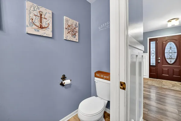 a bathroom with a toilet and a view of bathroom