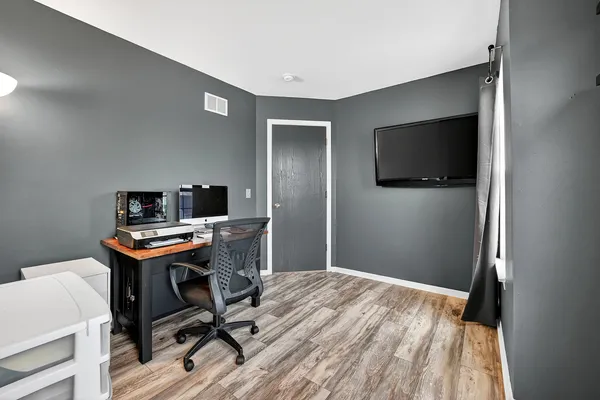 a workspace with a flat screen tv and a window