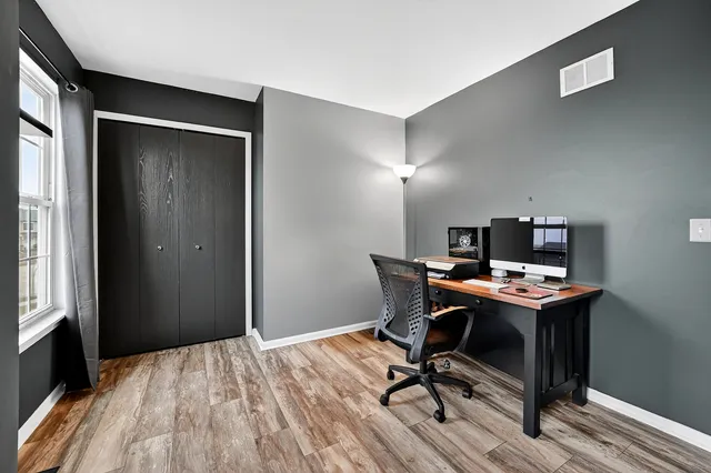 a view of a livingroom with an empty space and wooden floor