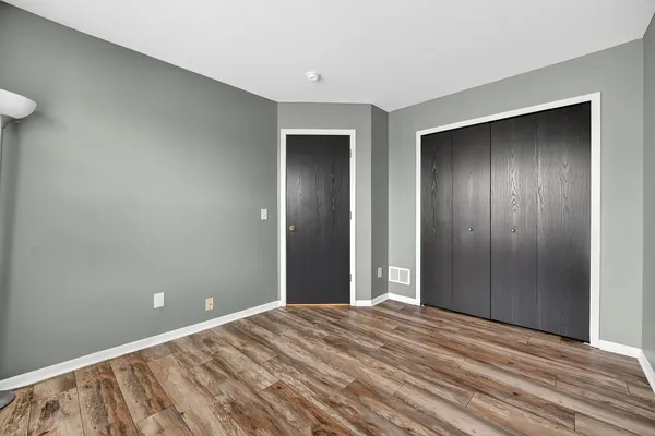 a view of a livingroom with an empty space and wooden floor