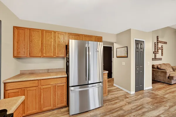 a kitchen with stainless steel appliances granite countertop a refrigerator microwave and sink