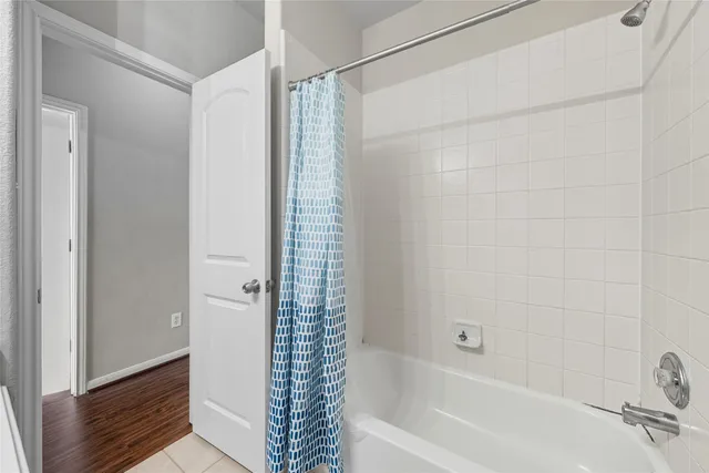 a bathroom with a bathtub and shower