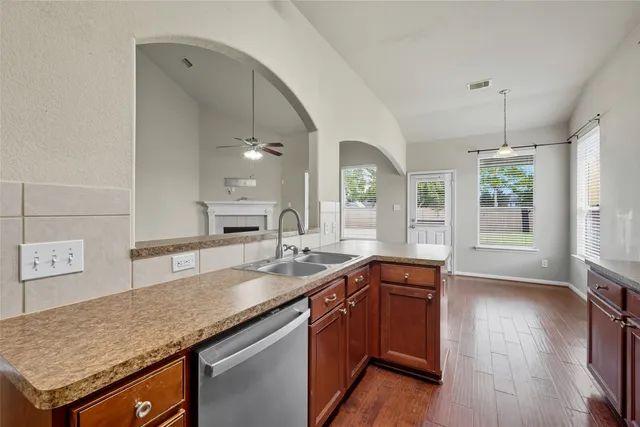 a kitchen with granite countertop a sink and stove
