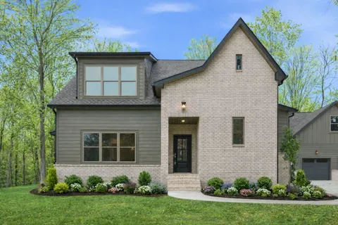 a view of a house with a yard and plants
