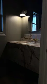 a bathroom with a tub a double vanity sink and mirror