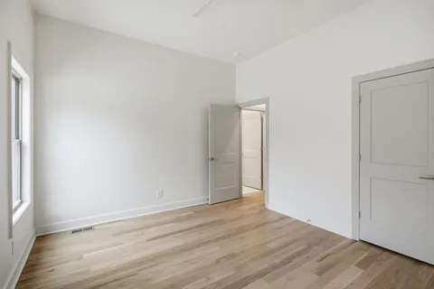 an empty room with windows and closet