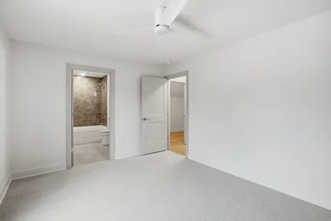 a bedroom with two beds and a window