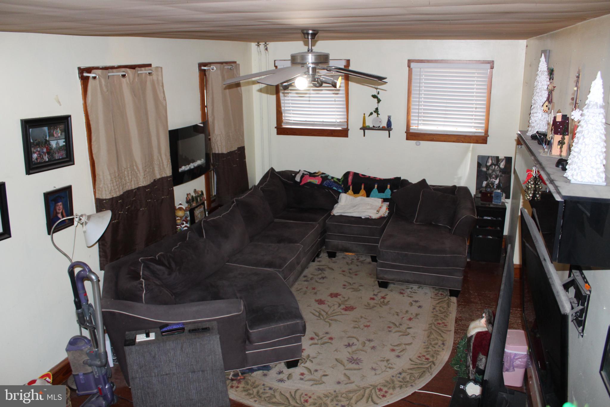 1616 Ward Street Linwood, PA 19061 - Photo 3 of 13 a living room with furniture a flat screen tv and a window