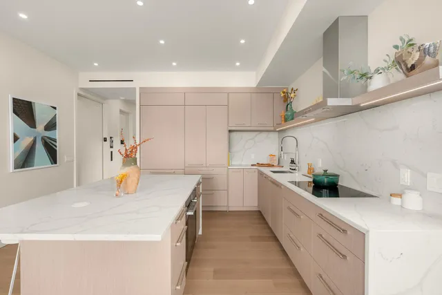 a kitchen with a sink a stove and cabinets