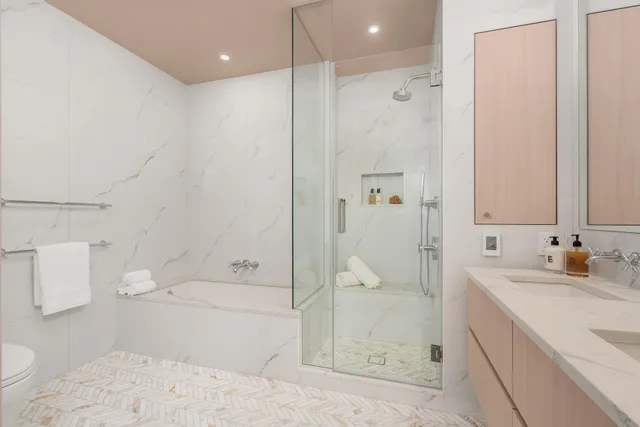 a bathroom with a granite countertop sink a toilet and shower