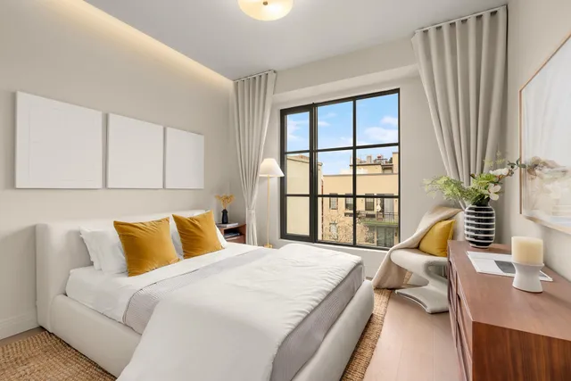 a bedroom with bed and a large window