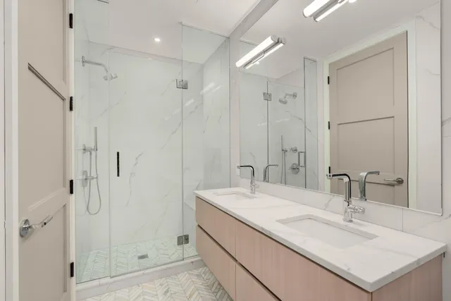 a bathroom with a sink double vanity and shower