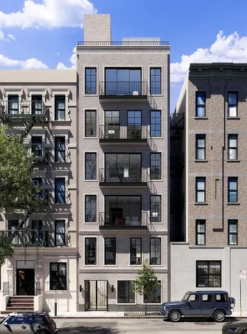 a front view of a residential apartment building with a yard