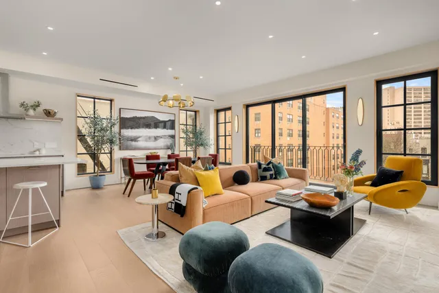 a living room with furniture and floor to ceiling window