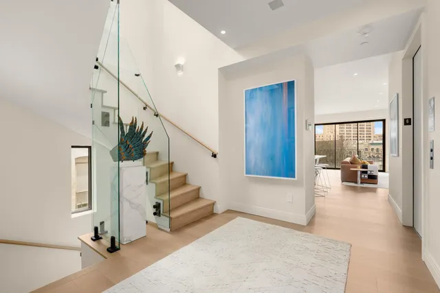 a view of entryway livingroom and hall with wooden floor