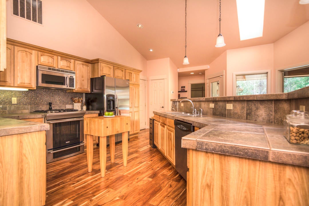 17065 Azusa Road Bend, OR 97707 - Photo 5 of 37 Large, open kitchen with a gas cooktop and a long island with bar seating.
