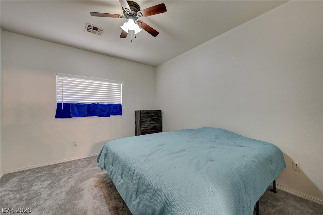 4730 East Craig Road, Unit 1155 Las Vegas, NV 89115 - Photo 22 of 41 Well-lit sleeping quarters with a vaulted ceiling and functional fan, offering a comfortable personal space.