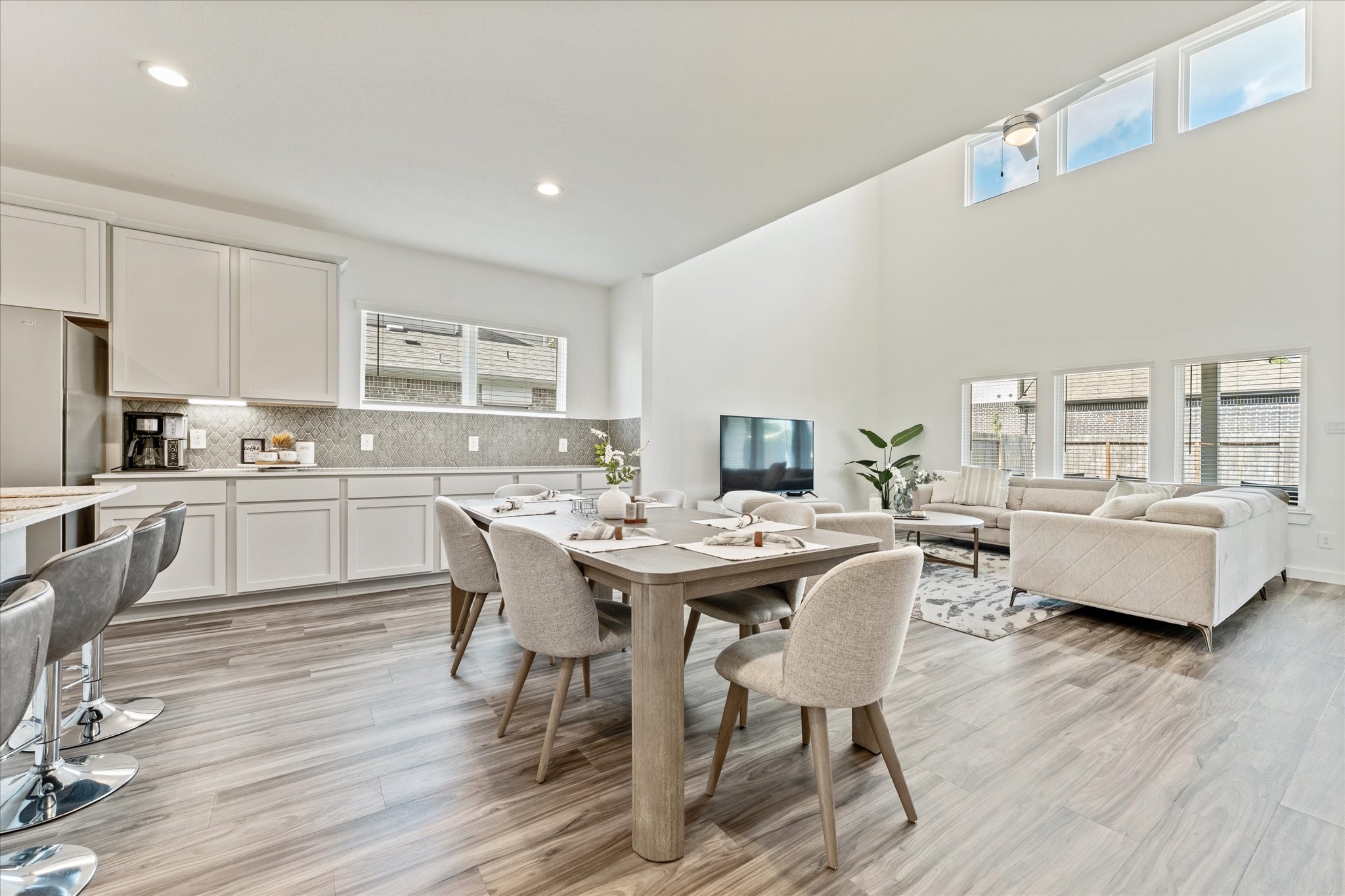 10212 Prairie Creek Lane Conroe, TX 77384 - Photo 13 of 41 a kitchen with a dining table chairs and wooden floor