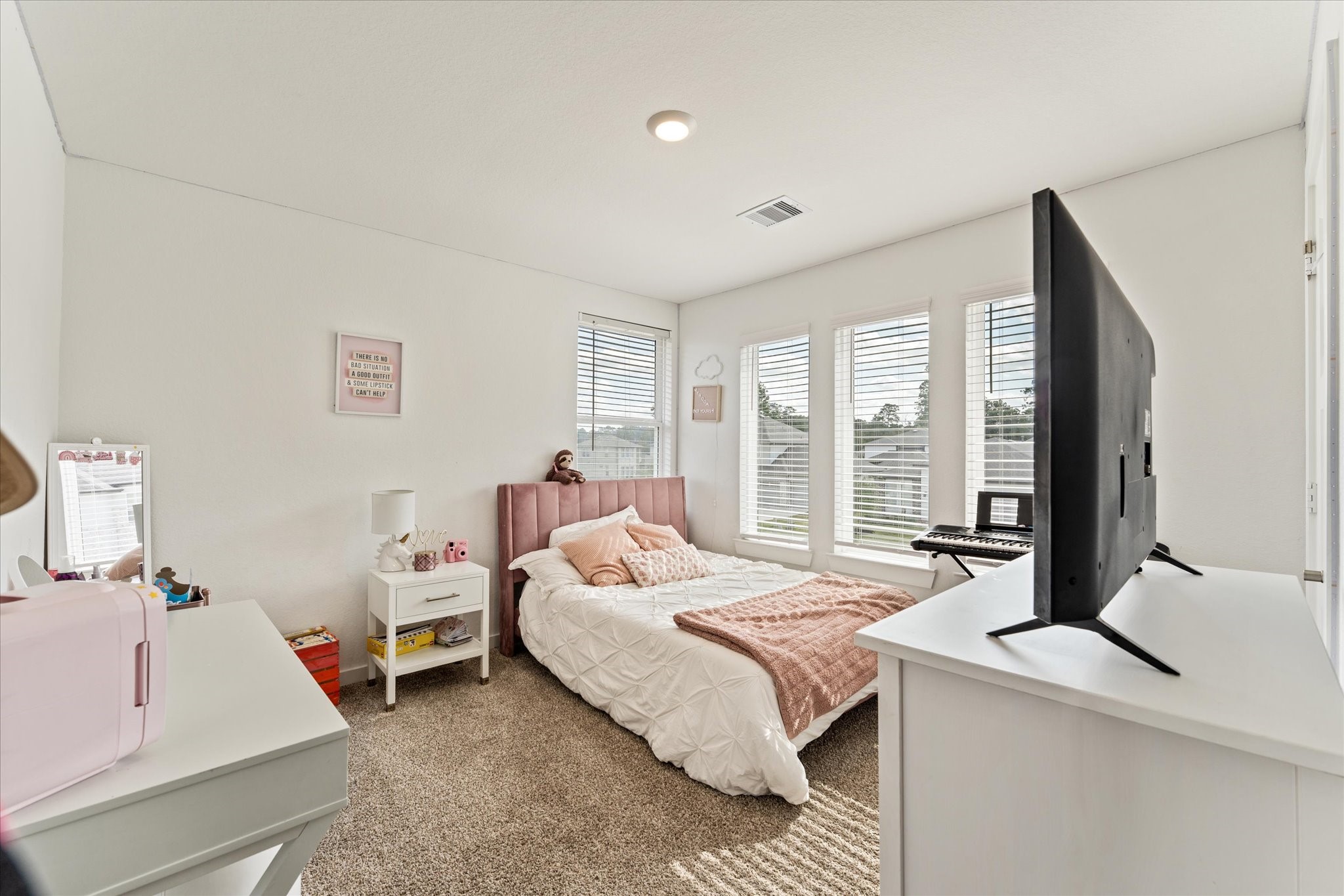10212 Prairie Creek Lane Conroe, TX 77384 - Photo 29 of 41 a bedroom with a bed and large windows