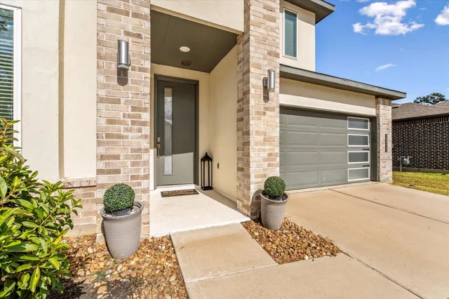 a front view of a house with potted plants
