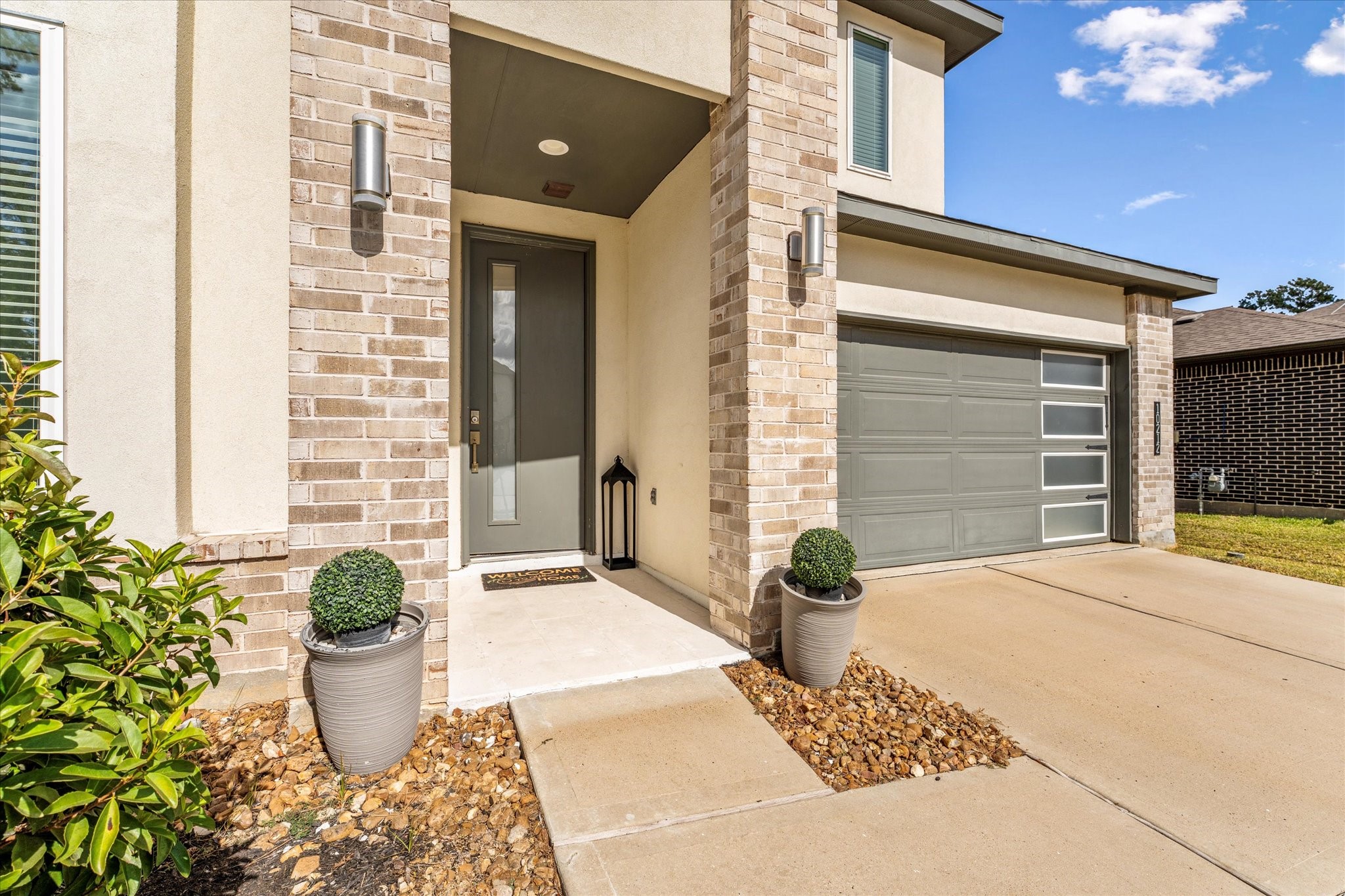 10212 Prairie Creek Lane Conroe, TX 77384 - Photo 3 of 41 a front view of a house with potted plants