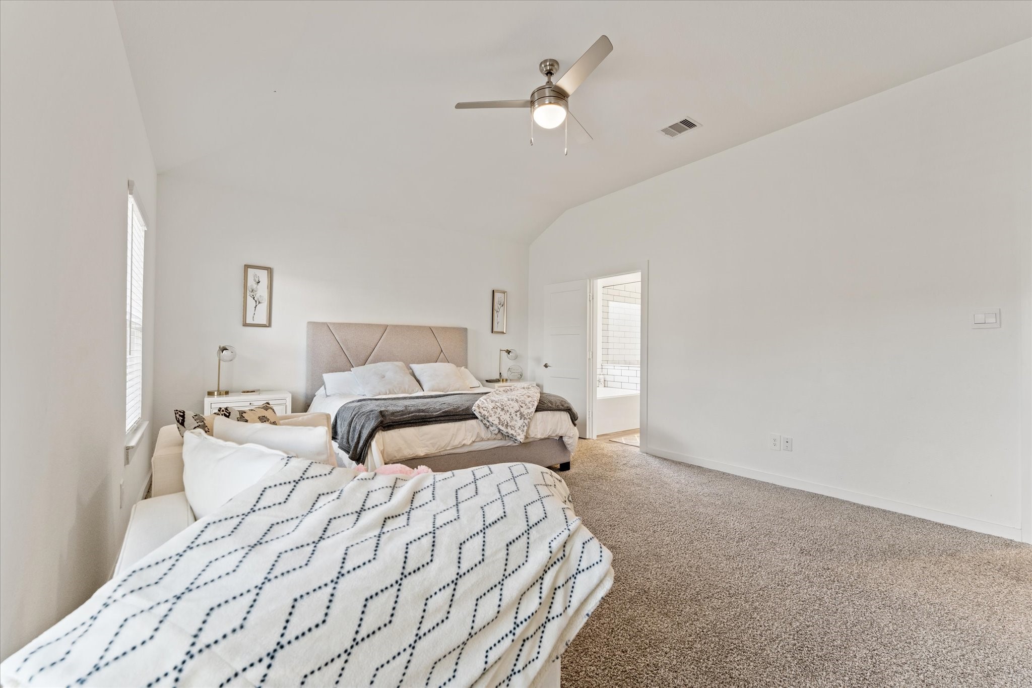 10212 Prairie Creek Lane Conroe, TX 77384 - Photo 32 of 41 a bedroom with a large bed and a chandelier