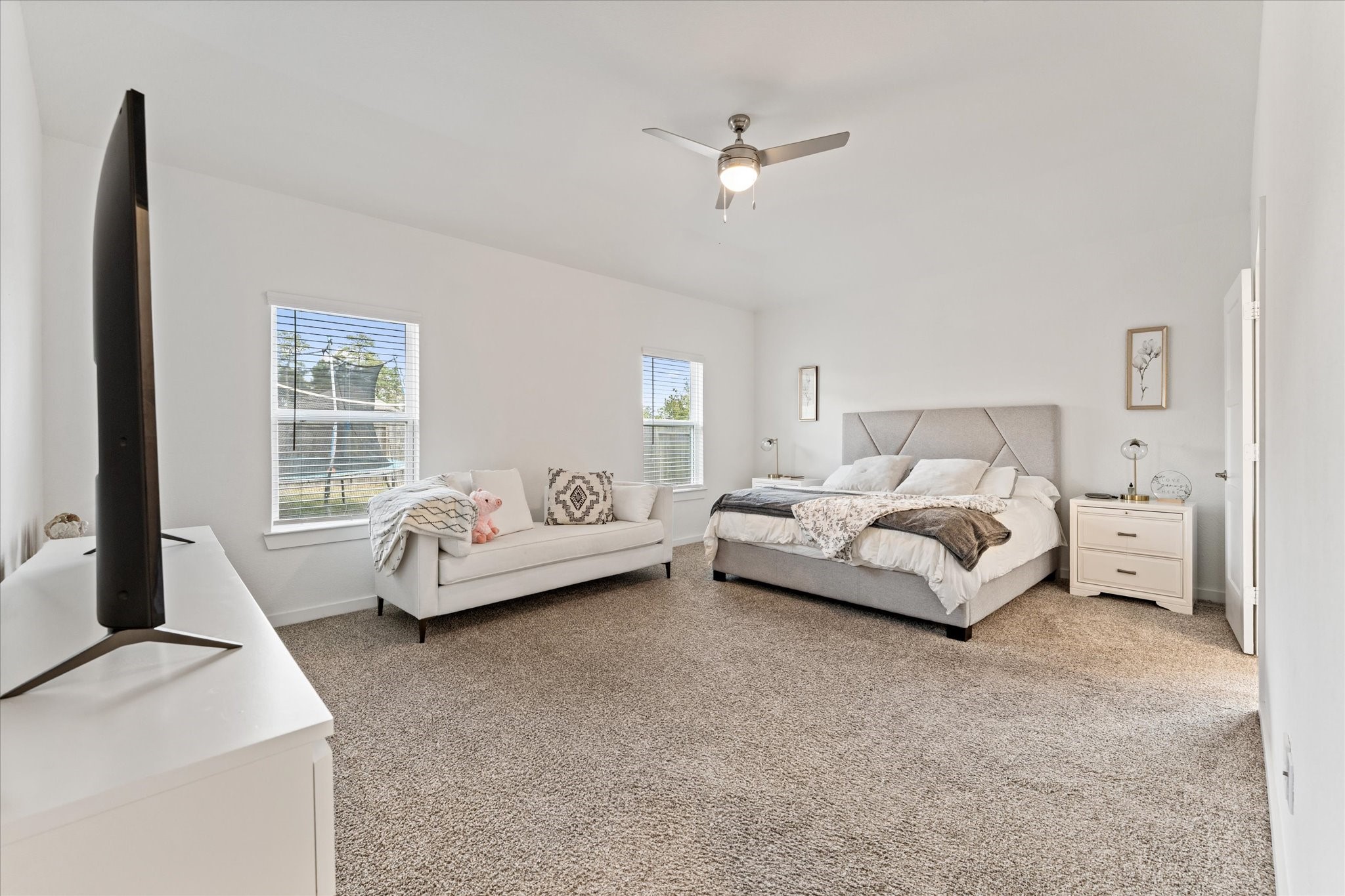 10212 Prairie Creek Lane Conroe, TX 77384 - Photo 33 of 41 a bedroom with bed and a large window