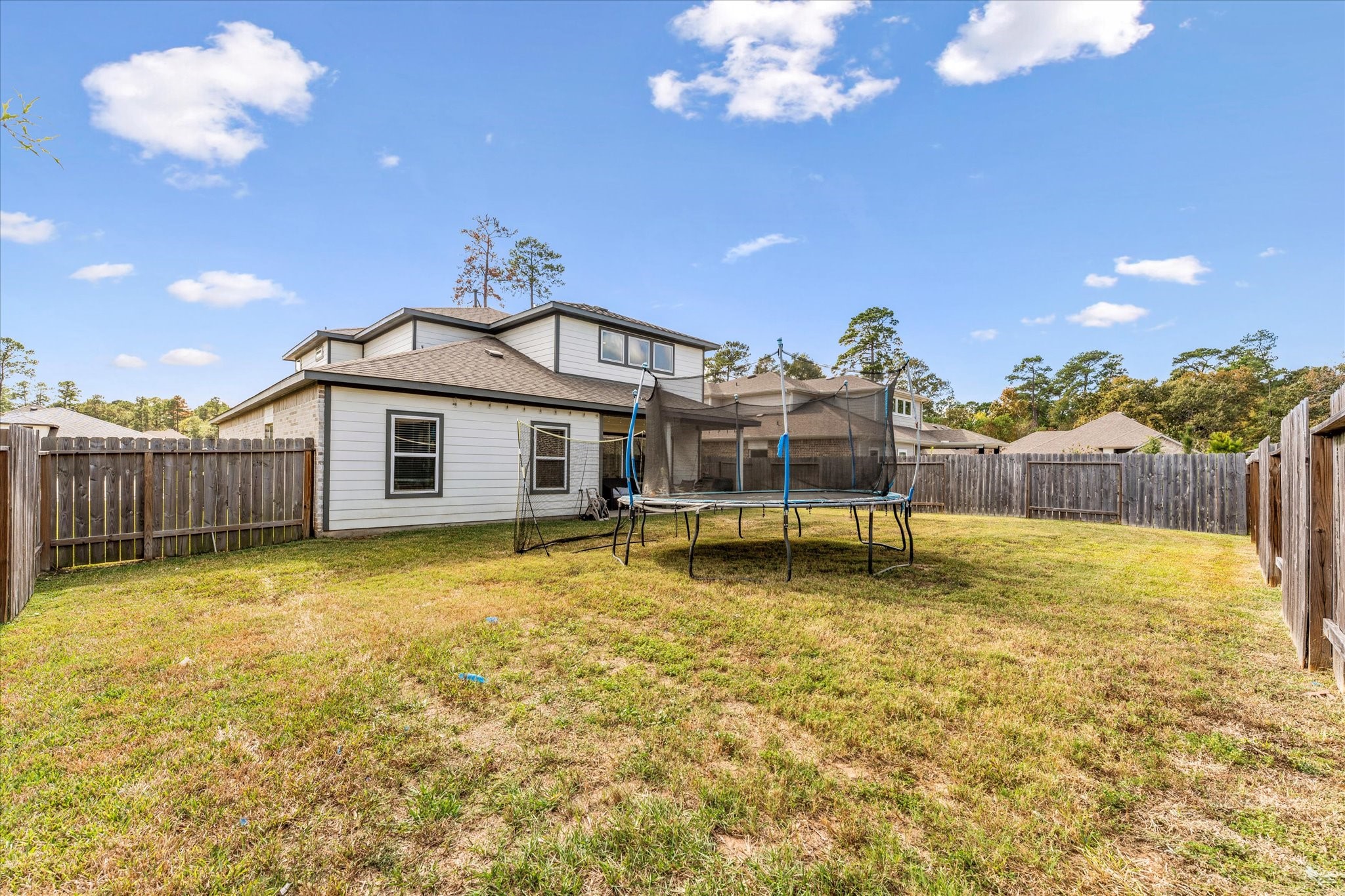10212 Prairie Creek Lane Conroe, TX 77384 - Photo 41 of 41 a swimming pool with some trees in the background