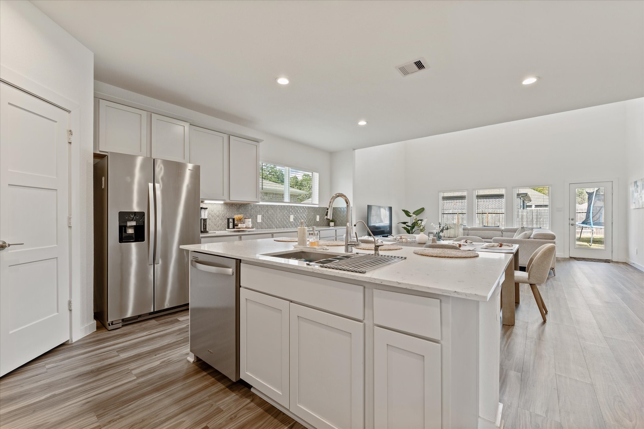 10212 Prairie Creek Lane Conroe, TX 77384 - Photo 9 of 41 a kitchen with a sink stainless steel appliances and cabinets