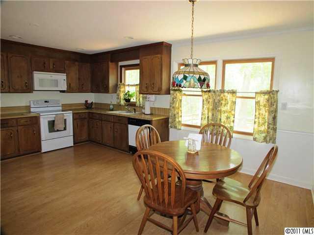 9601 Belt Road Midland, NC 28107 - Photo 7 of 16 a kitchen with stainless steel appliances granite countertop a stove a refrigerator a kitchen island a table and chairs