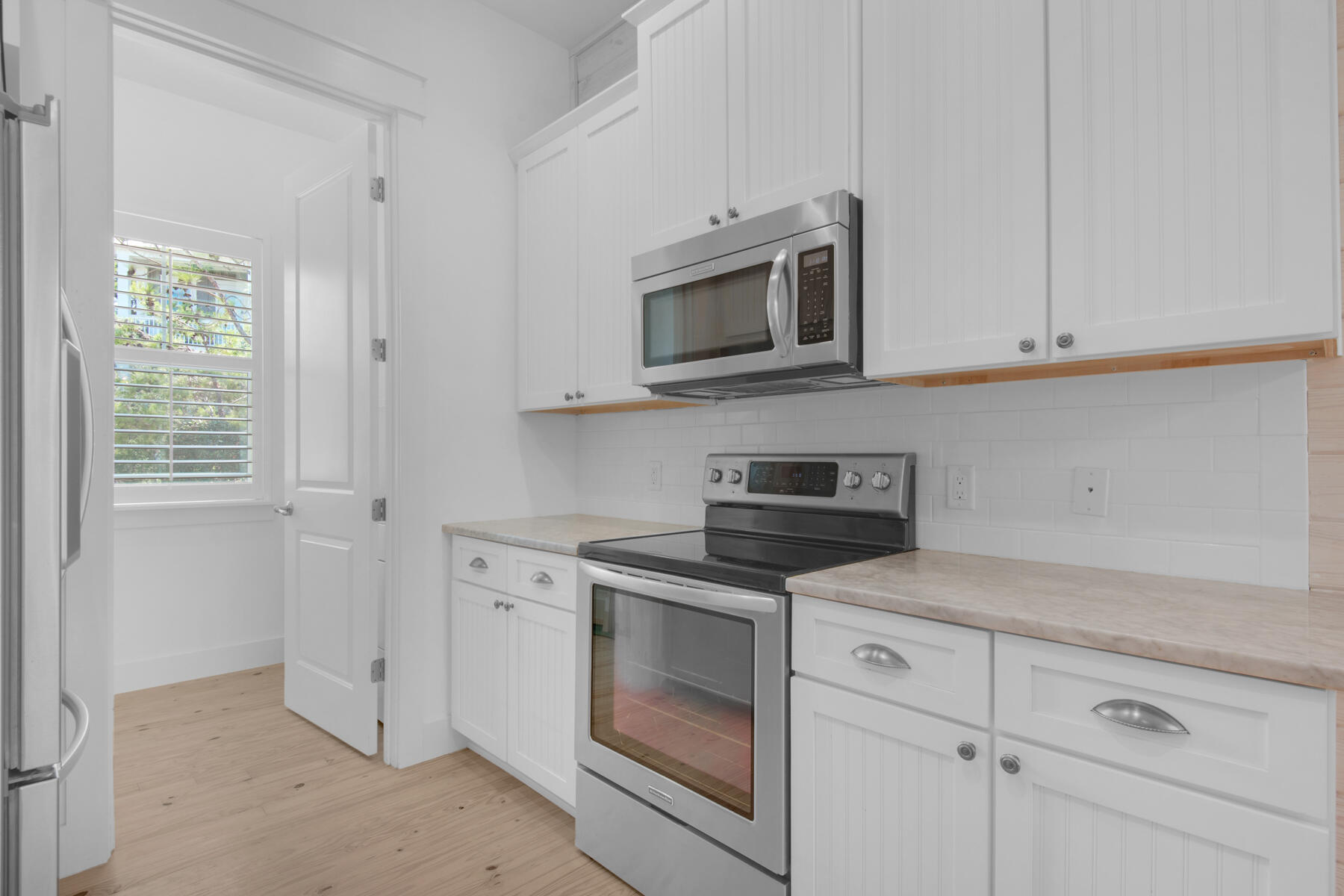 10 Gulfview Way Santa Rosa Beach, FL 32459 - Photo 9 of 30 a kitchen with white cabinets and appliances