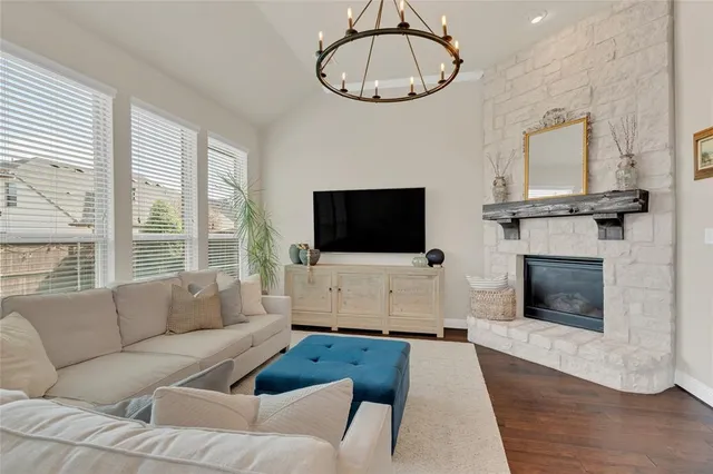 a living room with furniture and a dining table with kitchen view