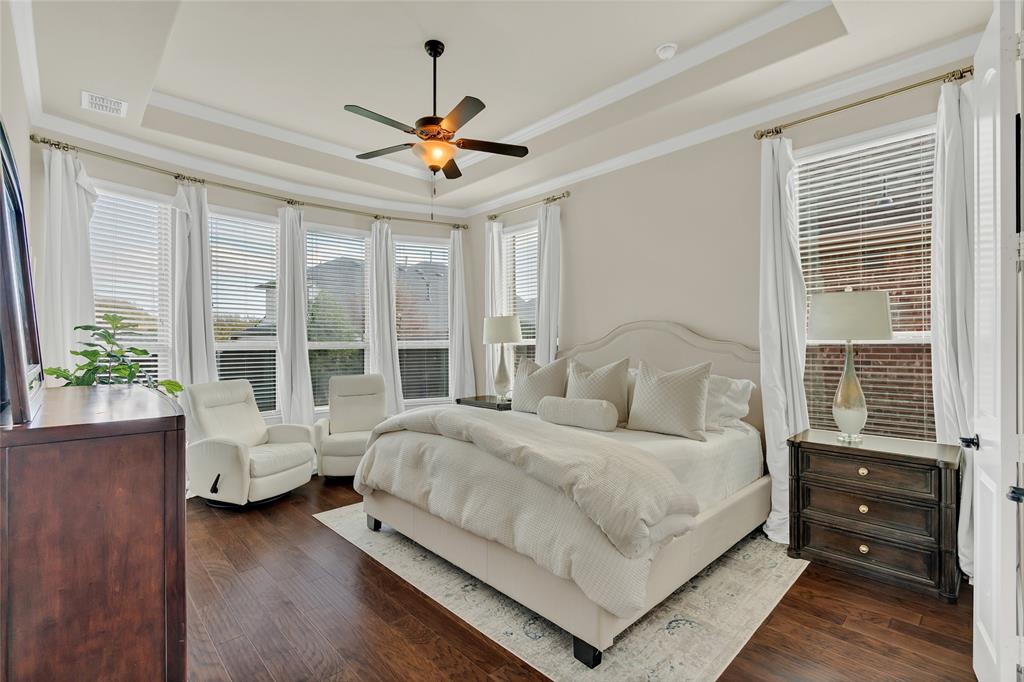 2852 Exeter Drive Trophy Club, TX 76262 - Photo 23 of 40 a bedroom with a large bed and wooden floor