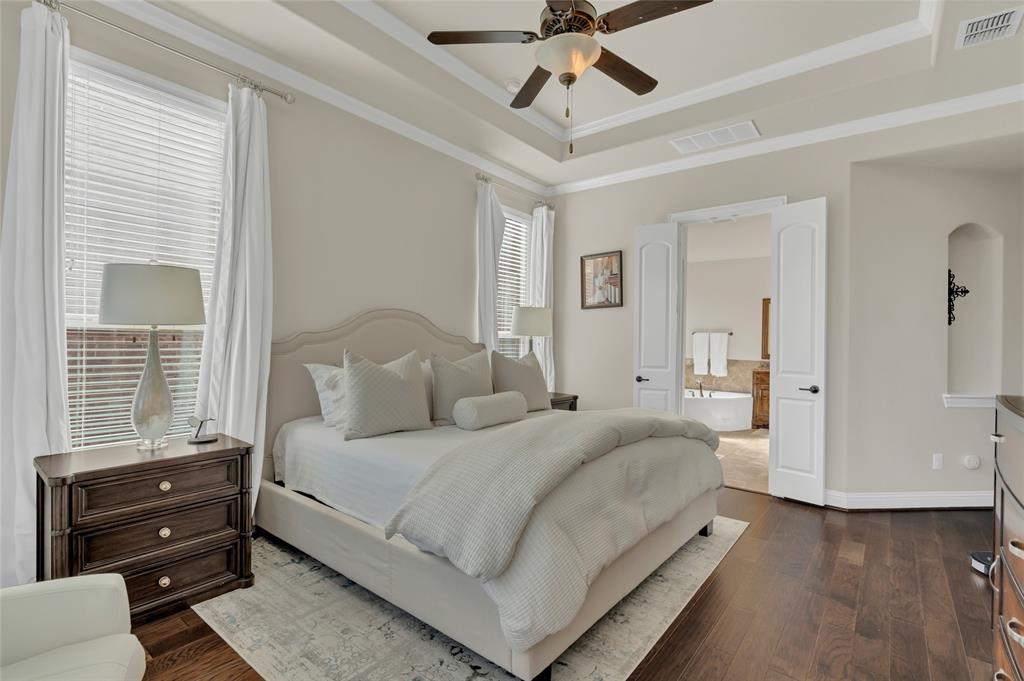 2852 Exeter Drive Trophy Club, TX 76262 - Photo 24 of 40 a bedroom with a bed and wooden floor