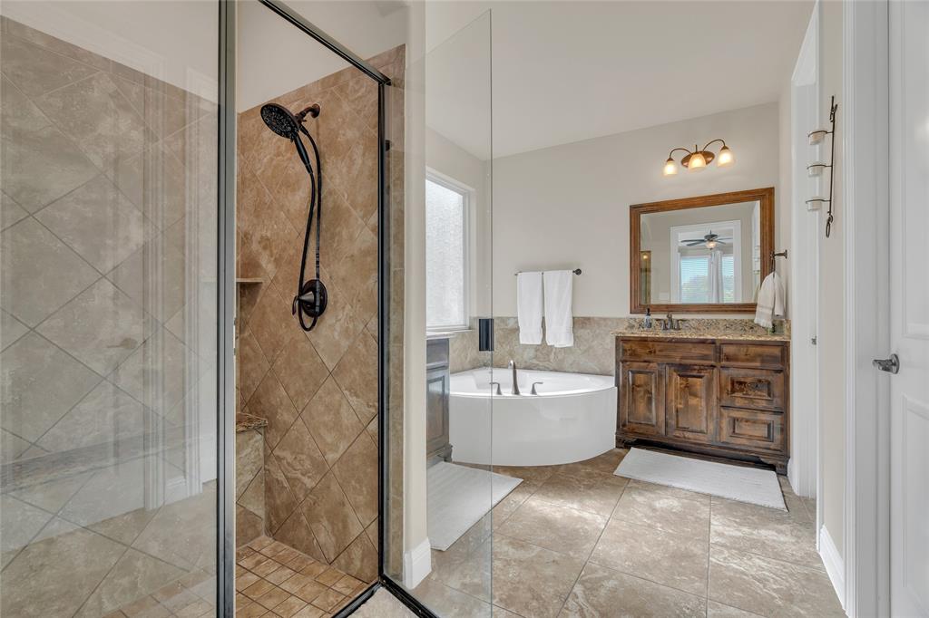 2852 Exeter Drive Trophy Club, TX 76262 - Photo 25 of 40 a en suite bathroom with a double vanity sink a mirror a bathtub and shower