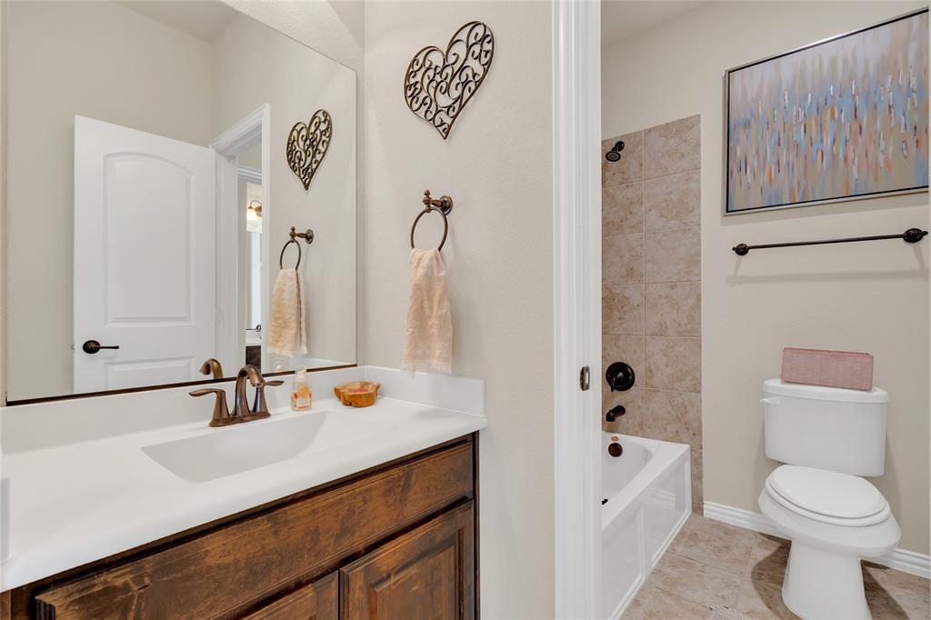 2852 Exeter Drive Trophy Club, TX 76262 - Photo 31 of 40 a bathroom with a sink a toilet and a mirror