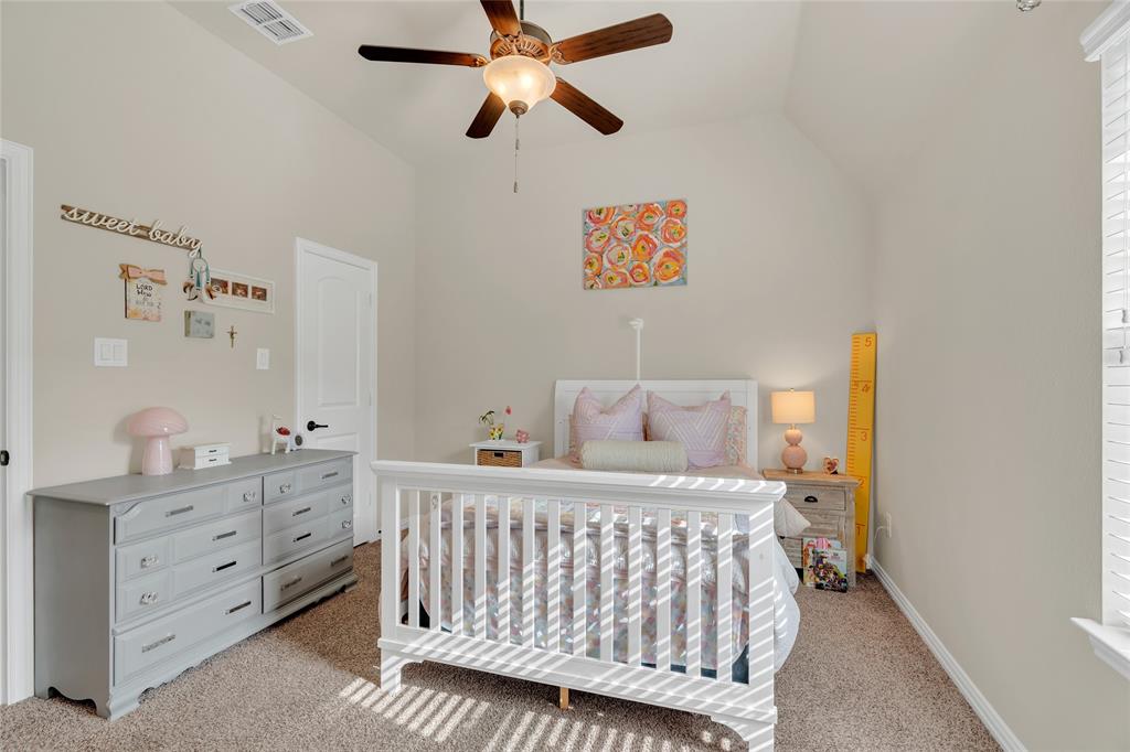 2852 Exeter Drive Trophy Club, TX 76262 - Photo 35 of 40 a bedroom with a bed and a chandelier