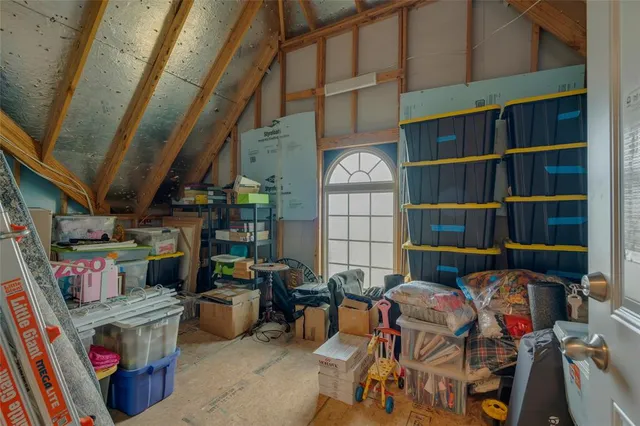 a bedroom with furniture and a window